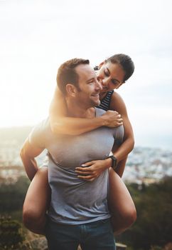 Where to next. a happy young couple enjoying a piggyback ride outdoors