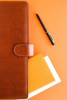 Modern workspace, productivity and corporate lifestyle concept - Luxury business brown brief-case on the office table desk, flatlay