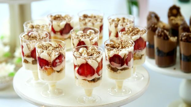 close-up, a variety of delicious desserts, cakes with cream, chocolate and strawberries. whipped cream with cinnamon. festive decor, a sweet bar, a corner, a treat. High quality photo