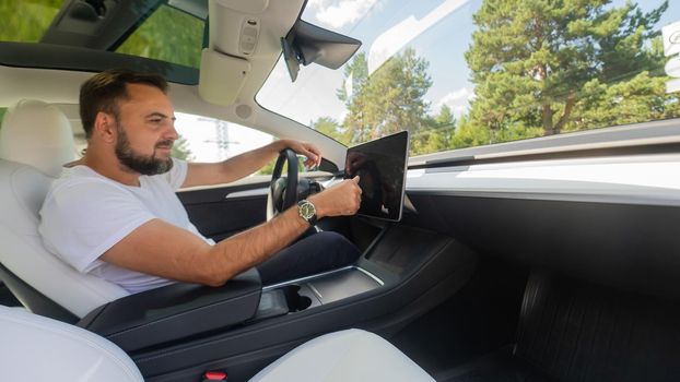 Caucasian man driving a modern electric car