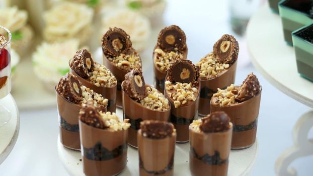 close-up, a variety of delicious desserts, cakes with chocolate and nuts. festive decor, sweet bar, confectionery masterpieces, treats. High quality photo
