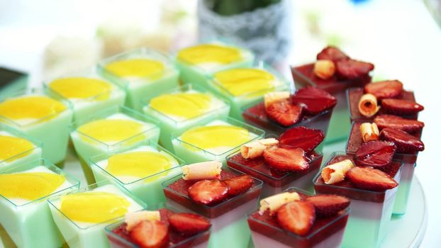 close-up, a variety of delicious desserts, cakes with cream, chocolate and strawberries. whipped cream with cinnamon. festive decor, a sweet bar, a corner, a treat. High quality photo