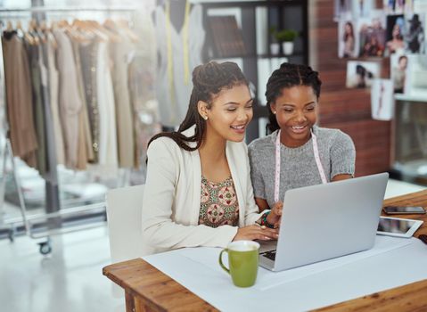 It all starts with a design. two young fashion designers working on a laptop