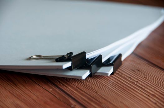Paper stack of pile of documents on wooden desk. Copy space and business offices concept.