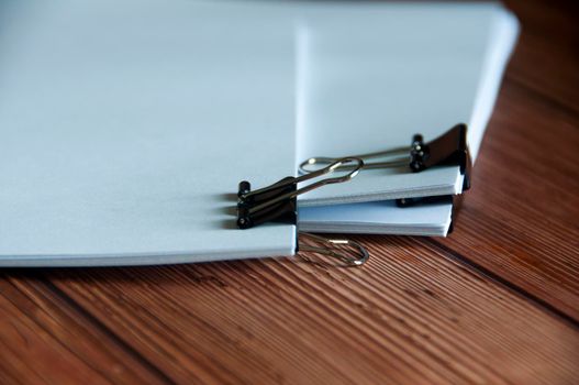 Paper stack of pile of documents on wooden desk. Copy space and business offices concept.