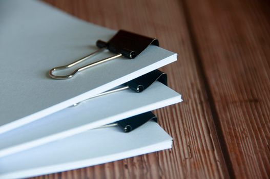Paper stack of pile of documents on wooden desk. Copy space and business offices concept.