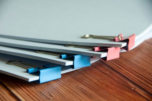 Paper stack of pile of documents on wooden desk. Copy space and business offices concept.