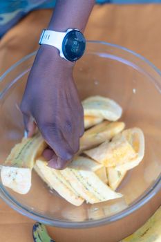 woman chef preparing african caribbean food with plantain plane tree fruit