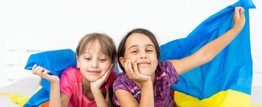 two little girls with the flag of ukraine