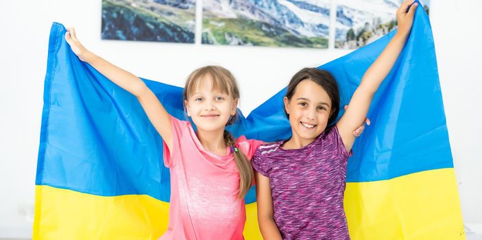 children carry fluttering flag of Ukraine. Ukraine's Independence Day. Flag Day. Constitution day. Girls with flag of Ukraine