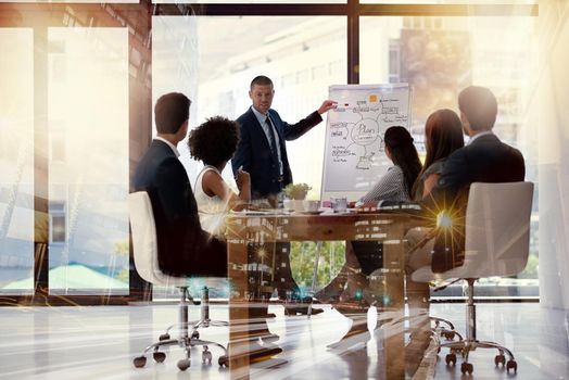 Theyve got big plans for expansion in the city. Multiple exposure shot of businesspeople having a meeting superimposed over a cityscape