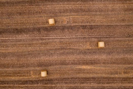 Aerial view of straw bales in a field after harvest in summer