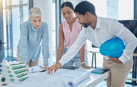 Design, construction and an architect in an office with blueprints, a city planning and strategy meeting. Architecture, engineering and apartment building plans, teamwork and communication at work