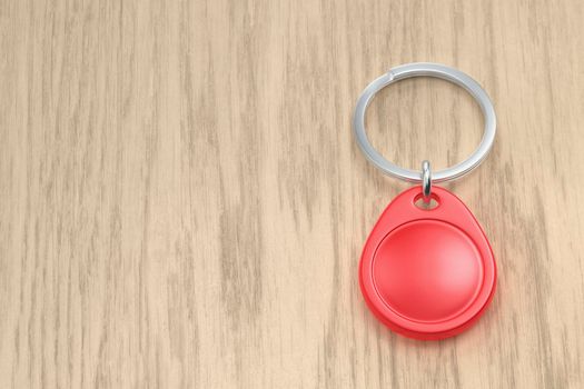 Red NFC key fob on the wooden desk