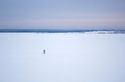 Skier on Great Russian River Volga in the Winter.