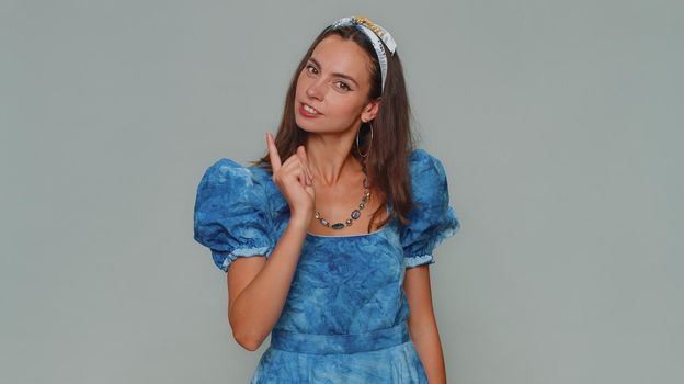 Quarrel. Displeased pretty young woman gesturing hands with irritation and displeasure, blaming scolding for failure, asking why this happened. Adult girl isolated on gray studio background indoors