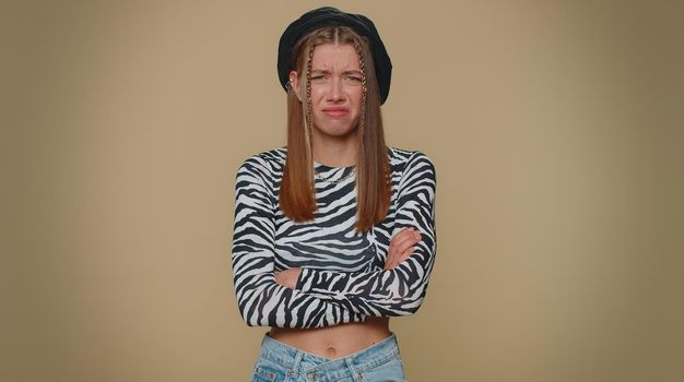 Dissatisfied pretty young woman asking reason of failure, expressing disbelief irritation, feeling bored, disappointed in result, bad news. Adult stylish girl isolated alone on beige studio background