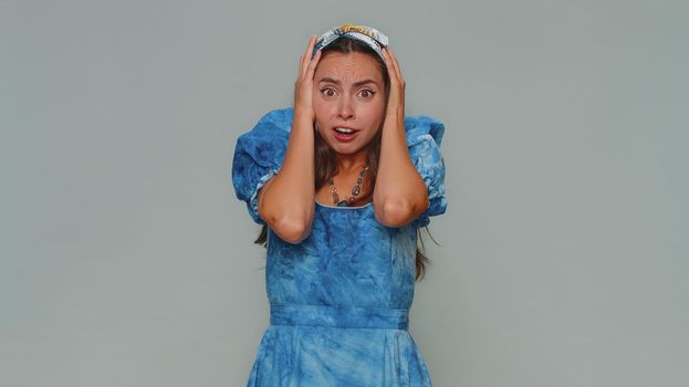 Stressed depressed woman terrified about danger problems, suffering phobia, anxiety disorder, expresses fear, waving no, insecure, stress, panic. Adult girl isolated on gray studio background indoors