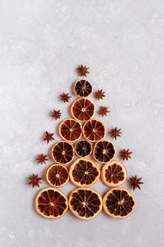 Christmas tree made of dry orange slices and decorated with anise stars, zero waste idea, top view