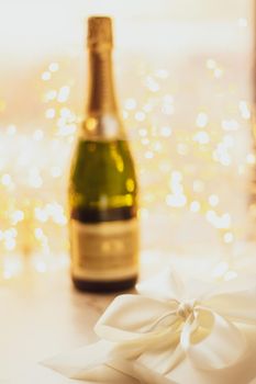 Romantic celebration, lifestyle and luxury present concept - The bottle of champagne and holiday gift box