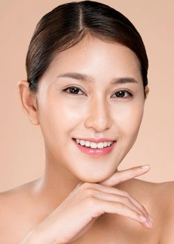 Closeup ardent young woman with healthy clear skin and soft makeup looking at camera and posing beauty gesture. Cosmetology skincare and beauty concept.