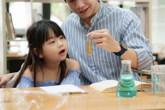 Kid and father doing science experiments. Education science concept.