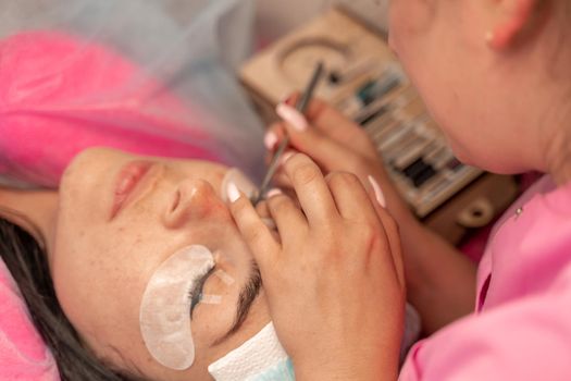 Eyelash extension procedure. Woman eye with long eyelashes. lashes, close up, macro, selective focus