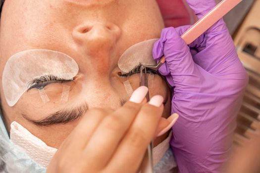 Eyelash extension procedure. Woman eye with long eyelashes. lashes, close up, macro, selective focus