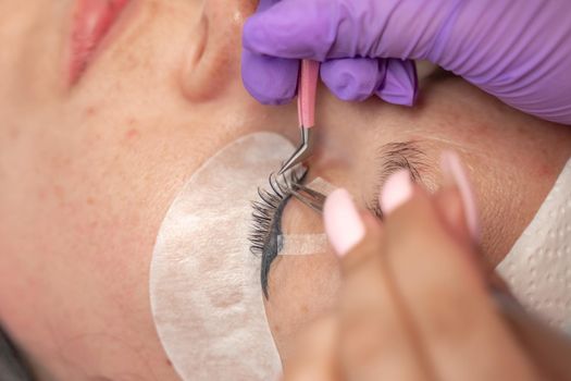 Eyelash extension procedure. Woman eye with long eyelashes. lashes, close up, macro, selective focus