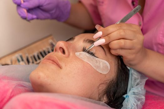 Eyelash extension procedure. Woman eye with long eyelashes. lashes, close up, macro, selective focus