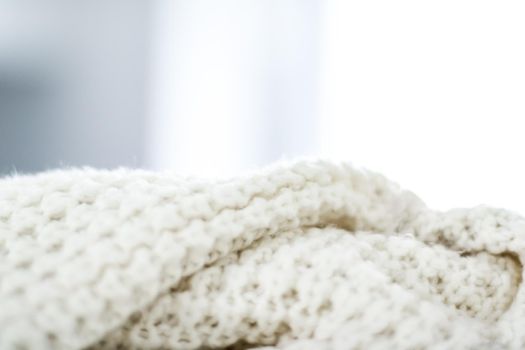 Knitwear, fabric textures and handmade items concept - Warm knitted clothes, soft and white