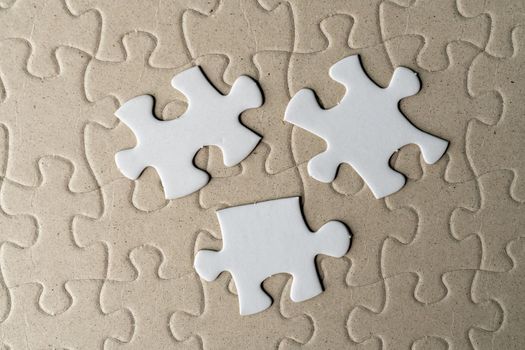 Three pieces of jigsaw puzzle on incomplete puzzle