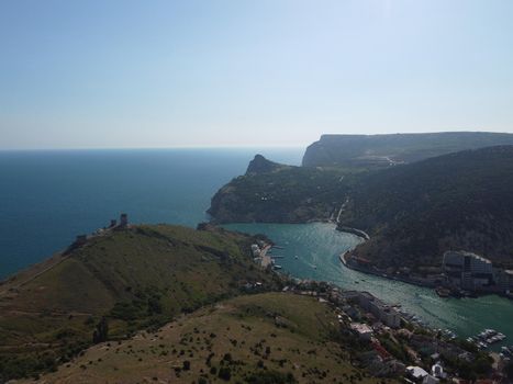 Aerial above Balaclava picturesque bay Crimea Sevastopol ancient resort city tourist attraction. Many yacht ships dock sail. Sea gulf of tectonic fault. Yachting on Black Sea coast film