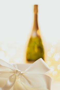 Romantic celebration, lifestyle and luxury present concept - The bottle of champagne and holiday gift box