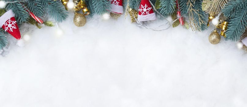 Banner with fir branches and Christmas decorations flat lay on a snowy background with copy space