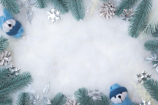 Frame made of Christmas decorations on a snowy background with copy space