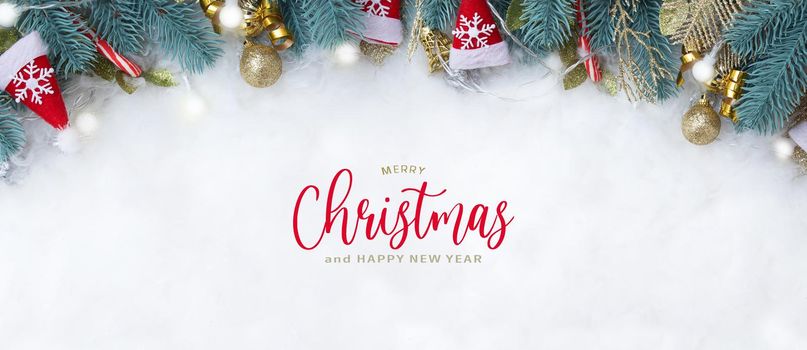 Banner with Merry Christmas text and fir branches Christmas decorations flat lay on a snowy background