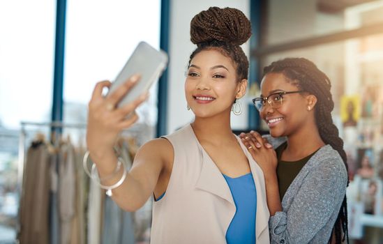 Were walking billboards of our own work. two young fashion designers taking a selfie at work