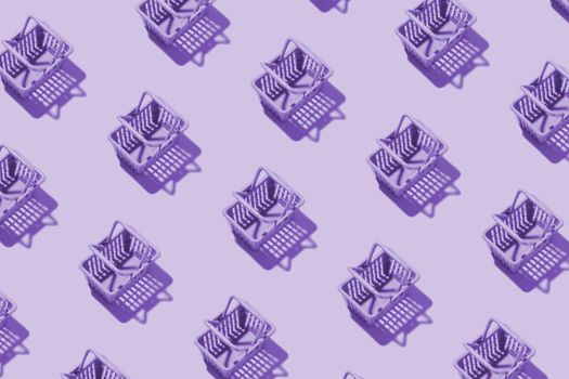 Pattern miniature shopping basket in a supermarket in purple tint. Minimalistic copy space shopping concept.