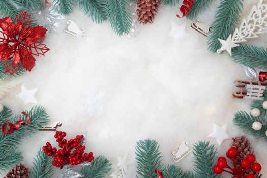 Frame made of Christmas decorations flat lay on a snowy background with copy space
