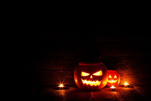 Halloween Jack O Lantern pumpkins and burning candles traditional decoration