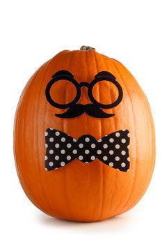 Fun halloween pumpkin in glasses and bow tie isolated on white background