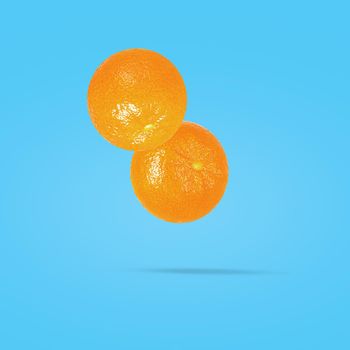 Minimal fruit concept. Whole mandarine on pastel blu background.