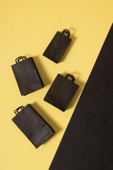 Black friday sale miniature mock up shopping bags black and yellow flat lay with copy space