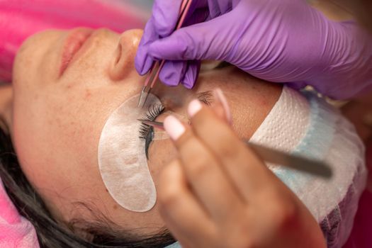 Eyelash extension procedure. Woman eye with long eyelashes. lashes, close up, macro, selective focus