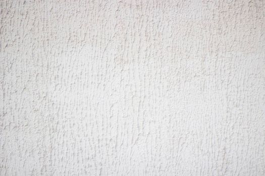 Texture background of concrete surface with artistic pattern of plaster. Bright grey monophonic surface.