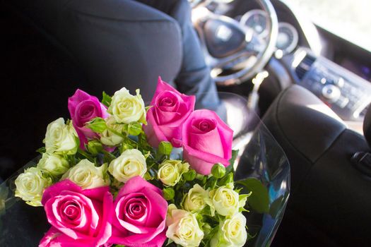 Groom rides for the uncountable with a huge bouquet of beautiful roses.