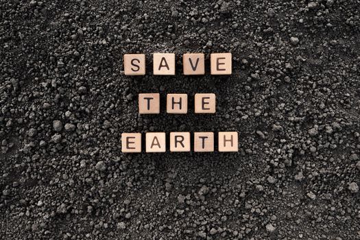 Letter block toy cube wood text Save the Earth word block wooden cubes concept world environment day. Black soil background earth day. Soil earth texture ground soil texture wooden block concept word