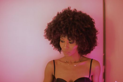 Young attractive African woman with happy cheerful smile having fun in studio