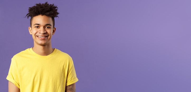 Close-up portrait of smiling, enthusiastic hispanic male student searching job, consider career opportunities, recruiting to company, smiling cheerful standing purple background.